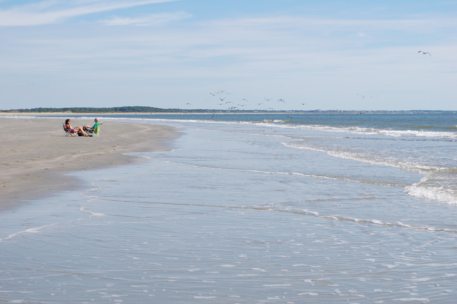 couple enjoys quiet beach with blue skies 