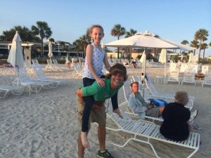 boy giving girl a piggyback ride
