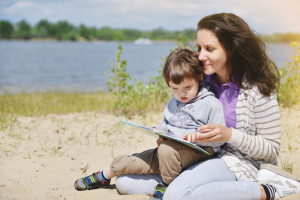 mother reading a book with her young son