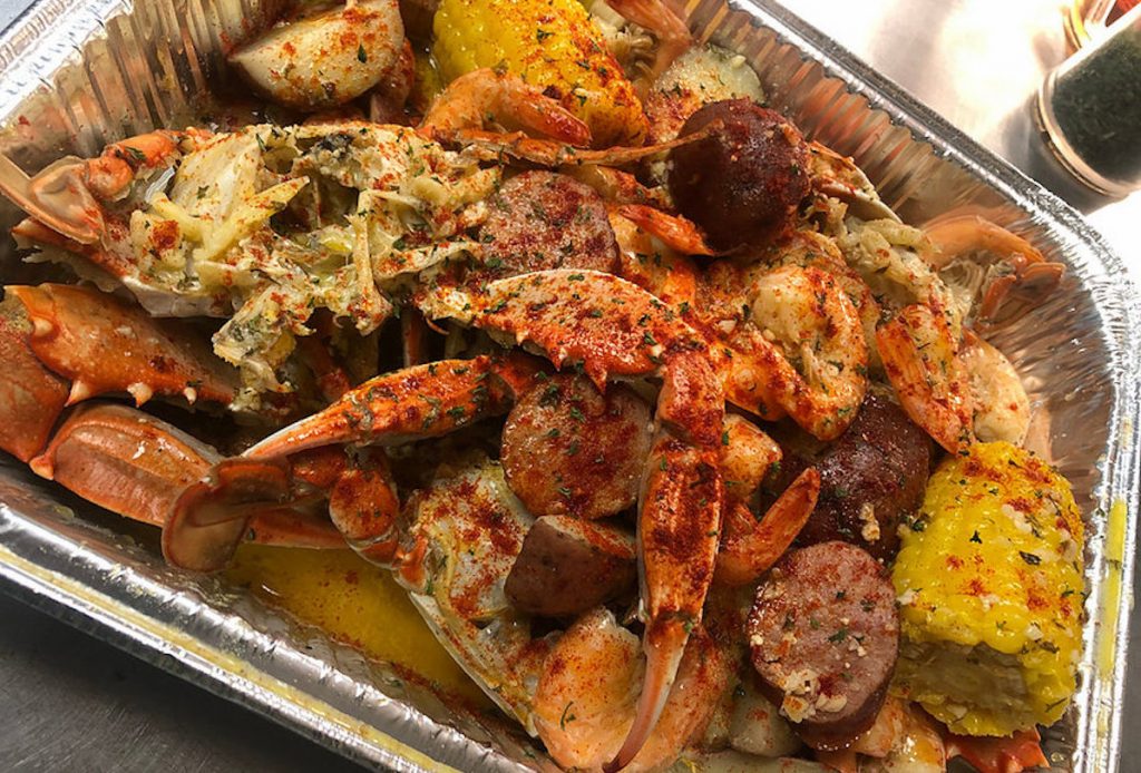 Sausage, seafood, corn, and potatoes served on a platter